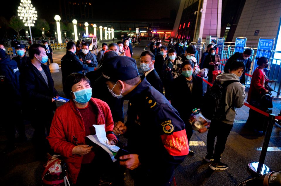  Passengers arrive at a train station in Wuhan