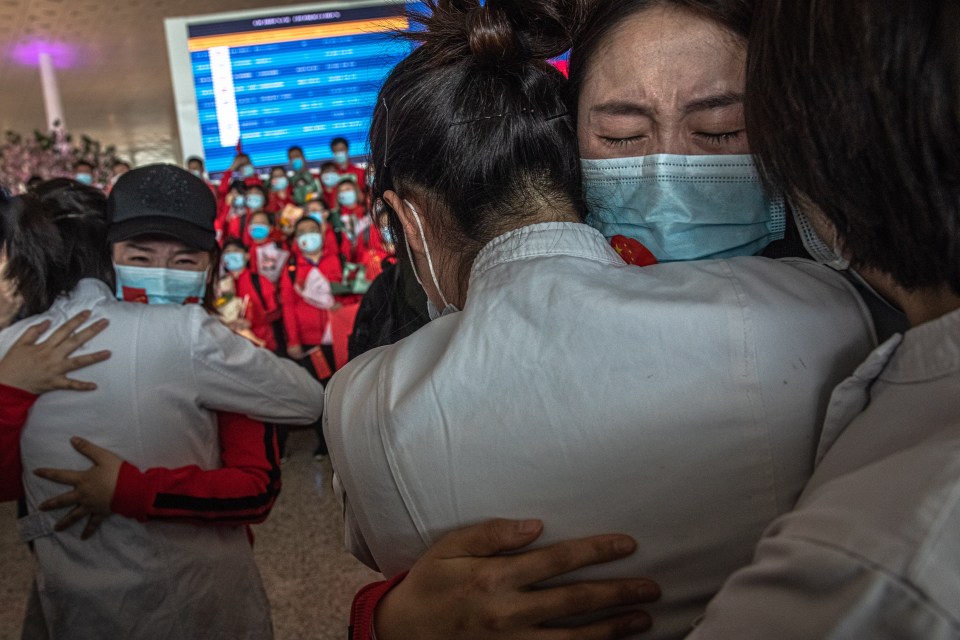  Medics hug after the 76-day lockdown was finally lifted