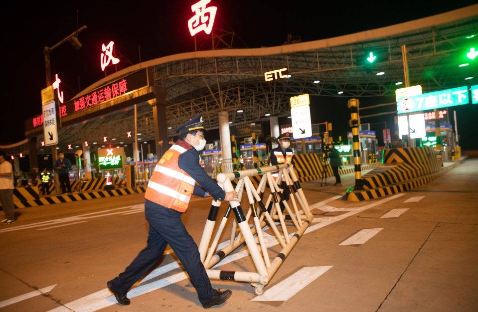  Traffic police lift a road blockade, Wuhan, Hubei Province in China