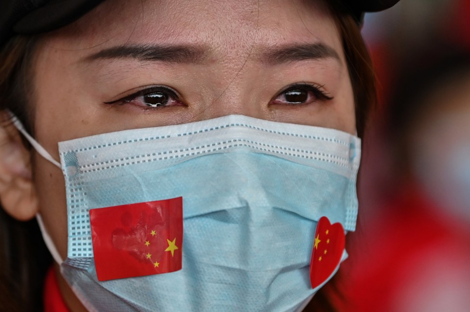  A medical staff member tears up as Tianhe Airport is reopened in Wuhan in China's central Hubei province on April 8