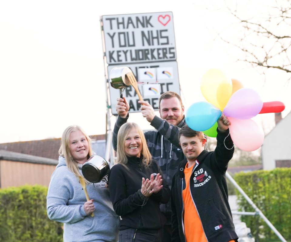  The Weeks family clap for the NHS with their roadside sign thanking key workers in Billericay