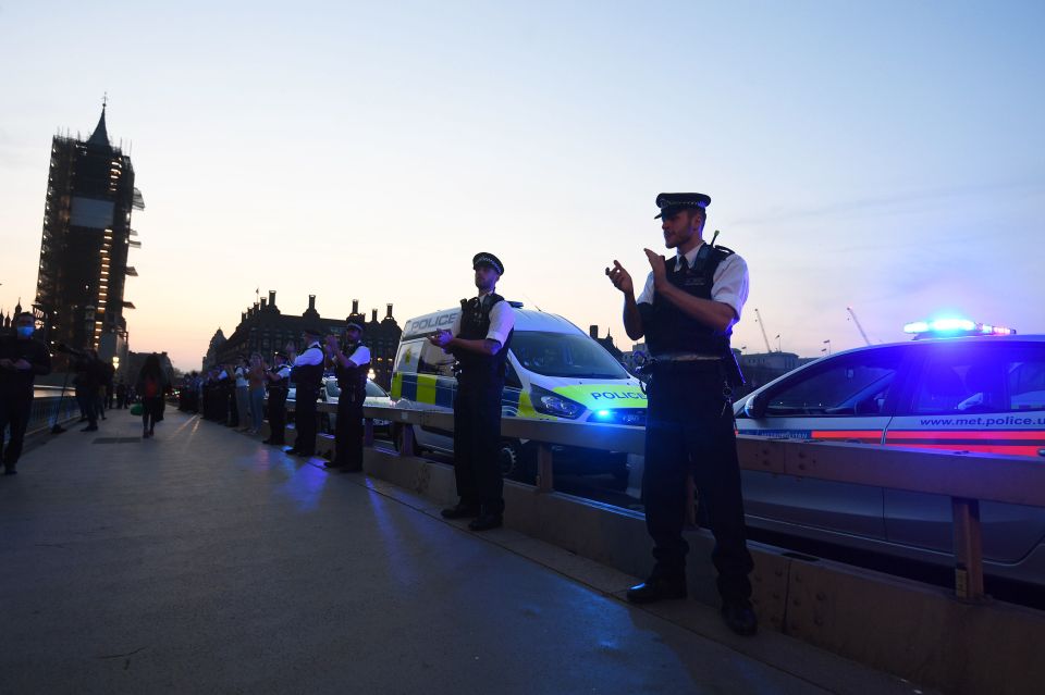  Police officers applaud near Chelsea and Westminster Hospital during the Clap for our Carers campaign