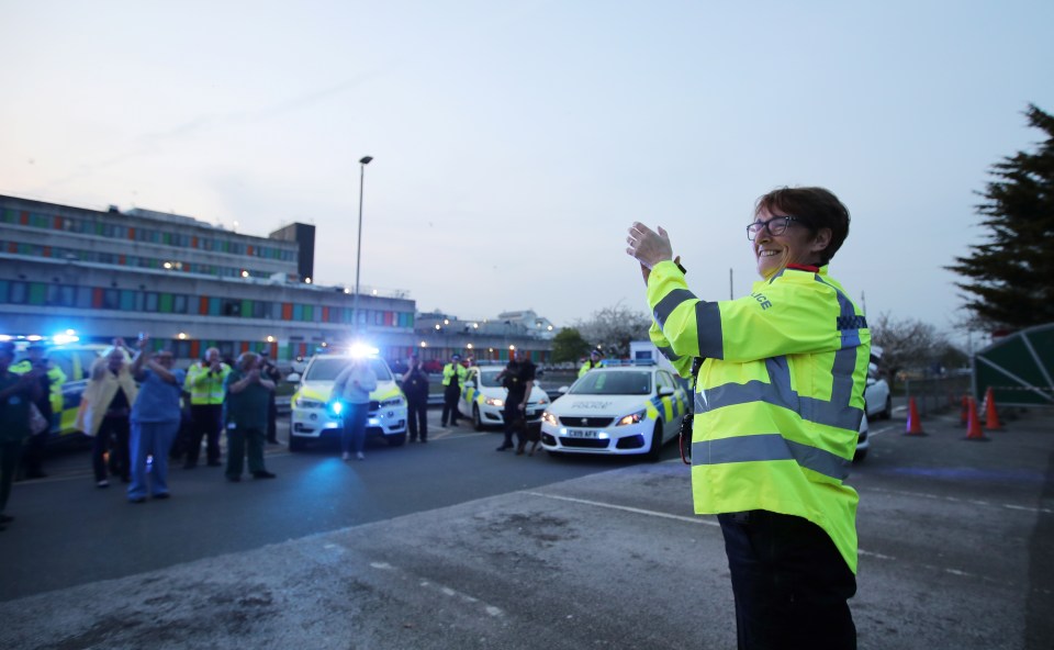  Police officers and NHS workers applaud outside Glan Clwyd Hospital