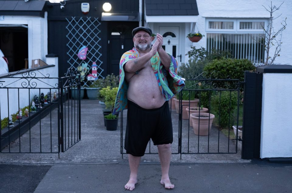  A man claps to show his appreciation for NHS and other key workers