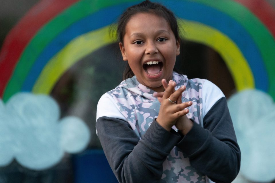  A girl claps to show her appreciation for NHS and other key workers in Cardiff