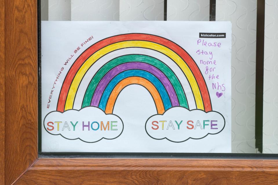  A poster shows showing a rainbow and words in support of the NHS