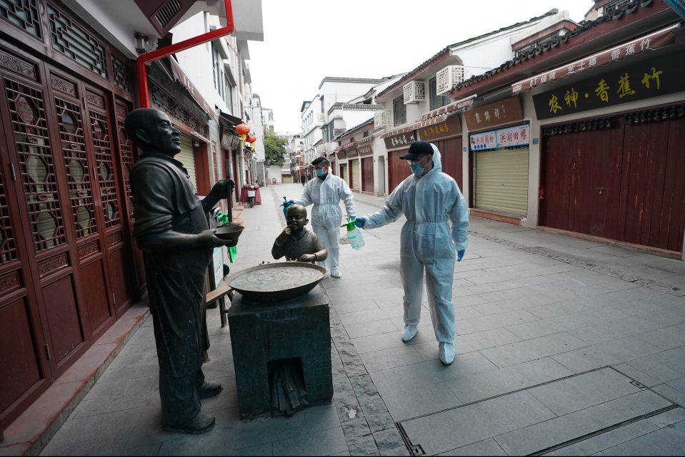 Workers disinfect a street in Wuhan, China, where the coronavirus outbreak started