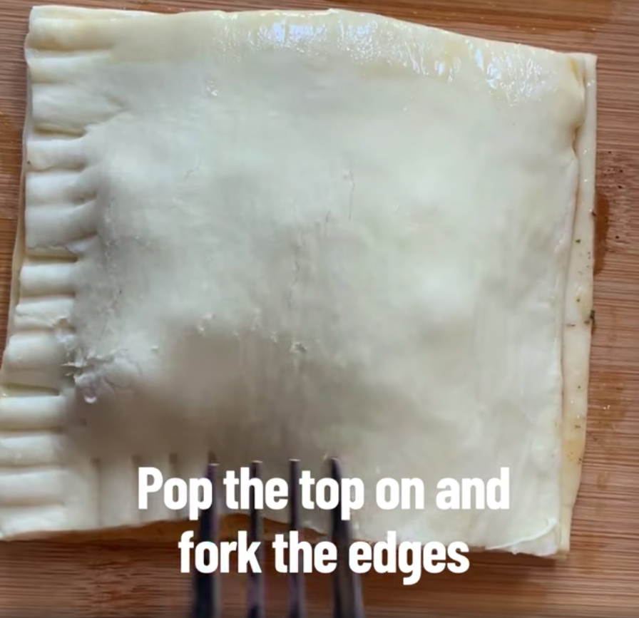 Add the other piece of pastry as a lid and fork the edges to seal it