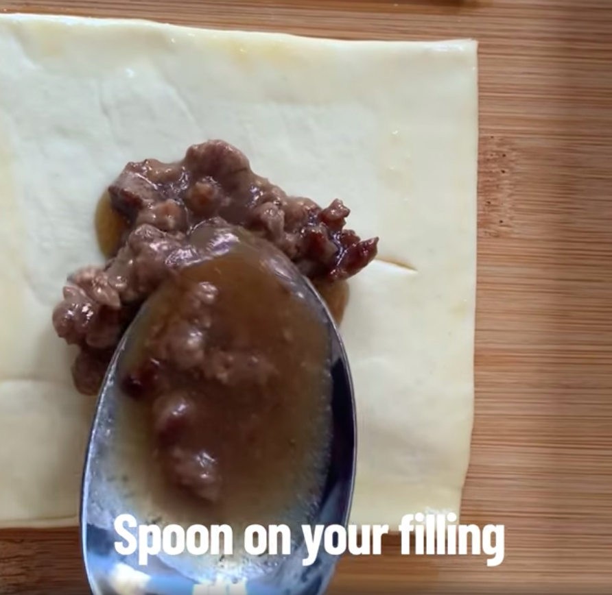 Add the beef to the middle of one of the pieces of puff pastry