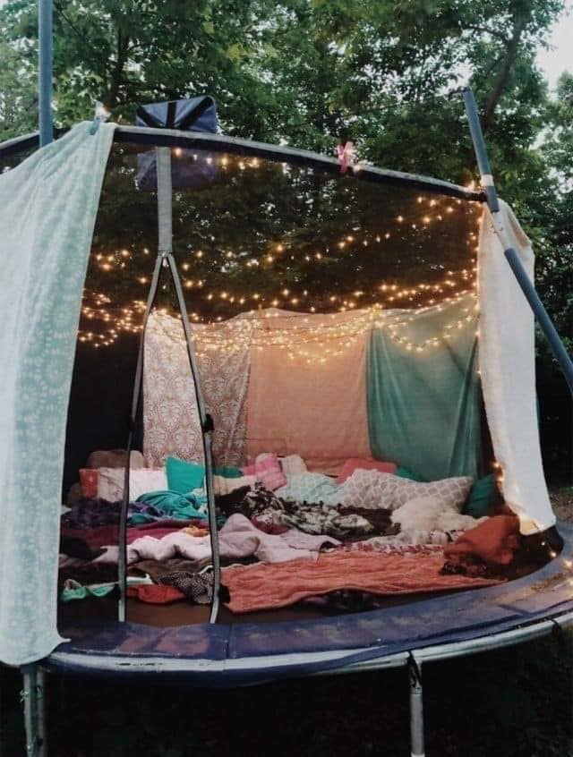 Parents are transforming their old trampolines into dens using cushions, blankets and fairy lights