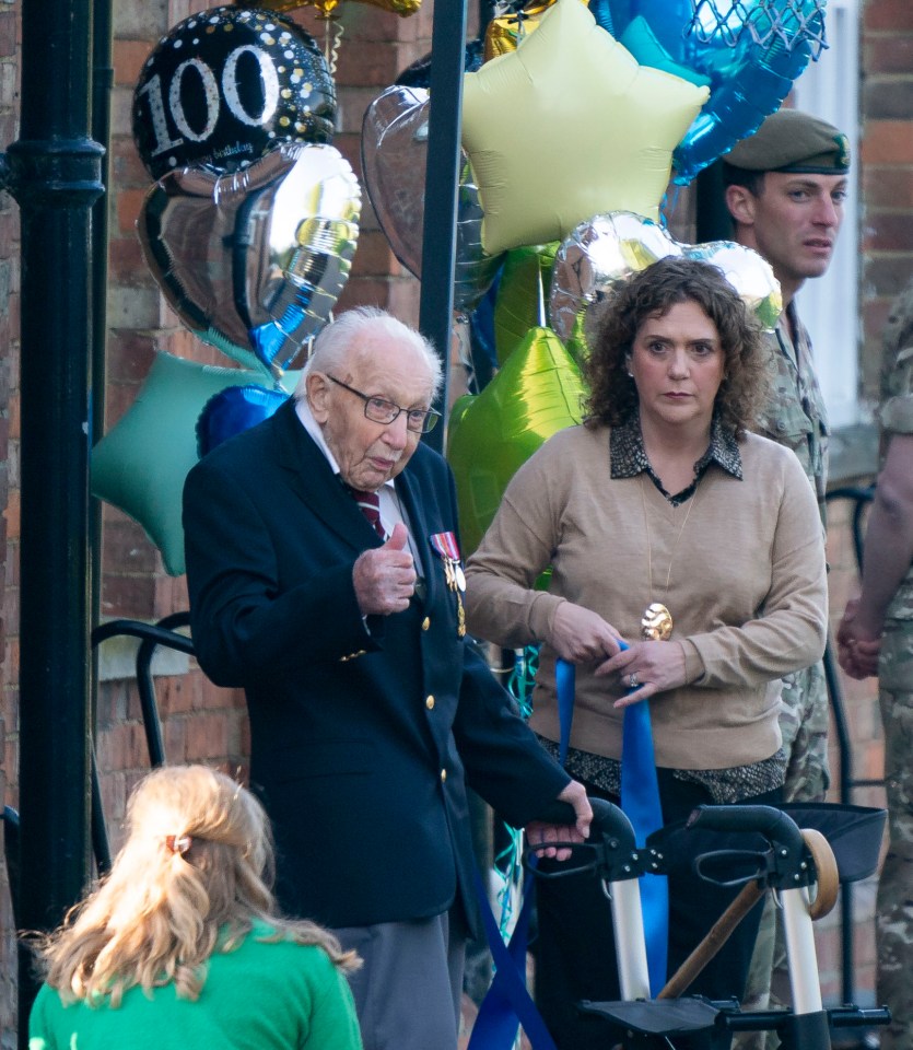  The 99-year-old gives supporters the thumbs-up at the end of his challenge