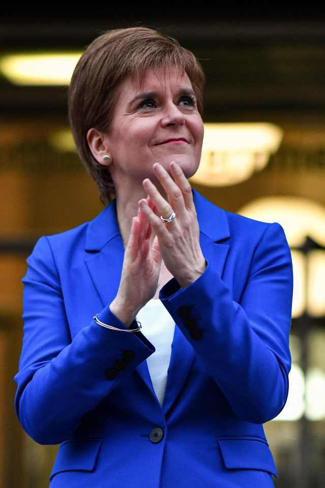  Nicola Sturgeon, seen here applauding the UK's NHS and care home workers, is calling for the UK government to unveil its coroanvirus exit strategy