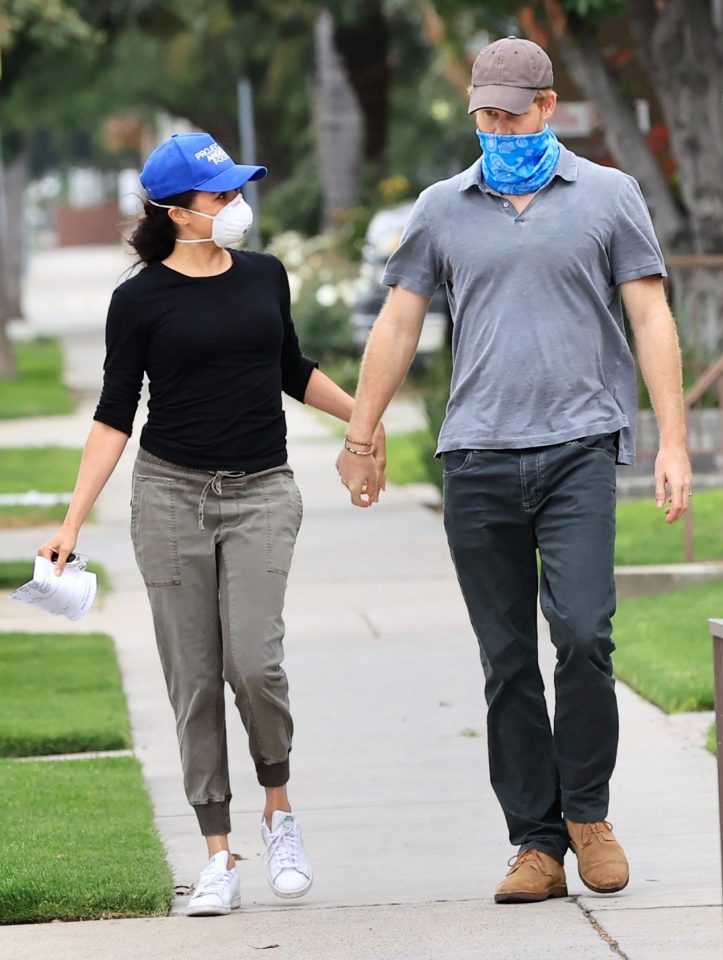  Meghan Markle and Prince Harry hold hands as they deliver food with the the non-profit organisation ‘Project Angel Food’