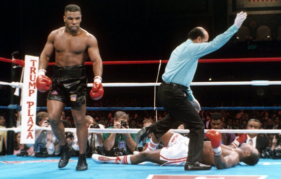  Mike Tyson walks away after landing a knockout blow on Holmes