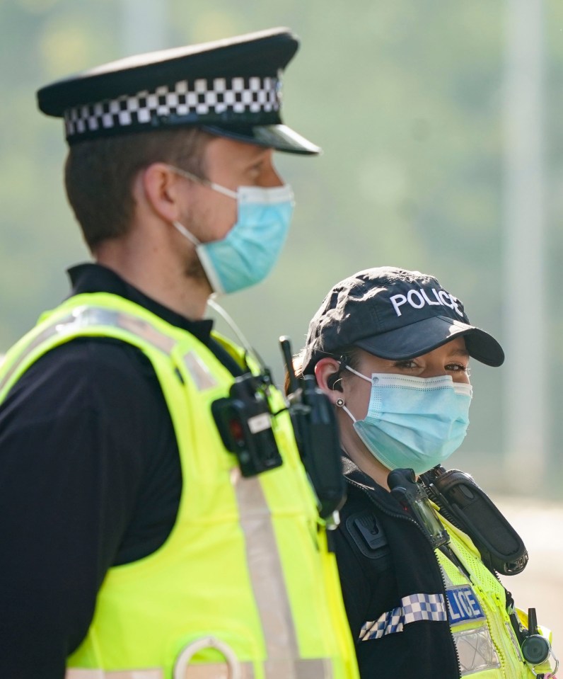  Police officers wear surgical face masks while out on patrol