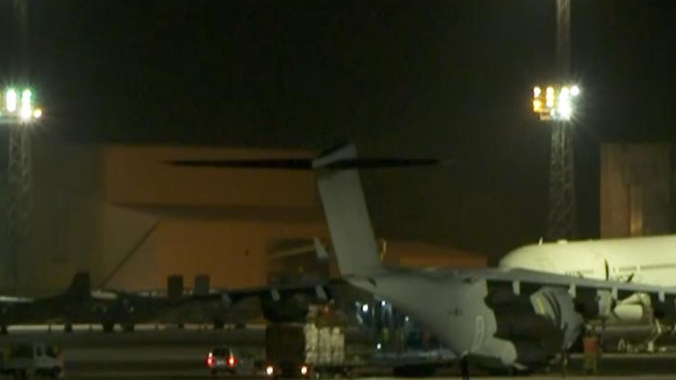 Pallets were seen being unloaded from the RAF jet after it landed at the Oxfordshire base