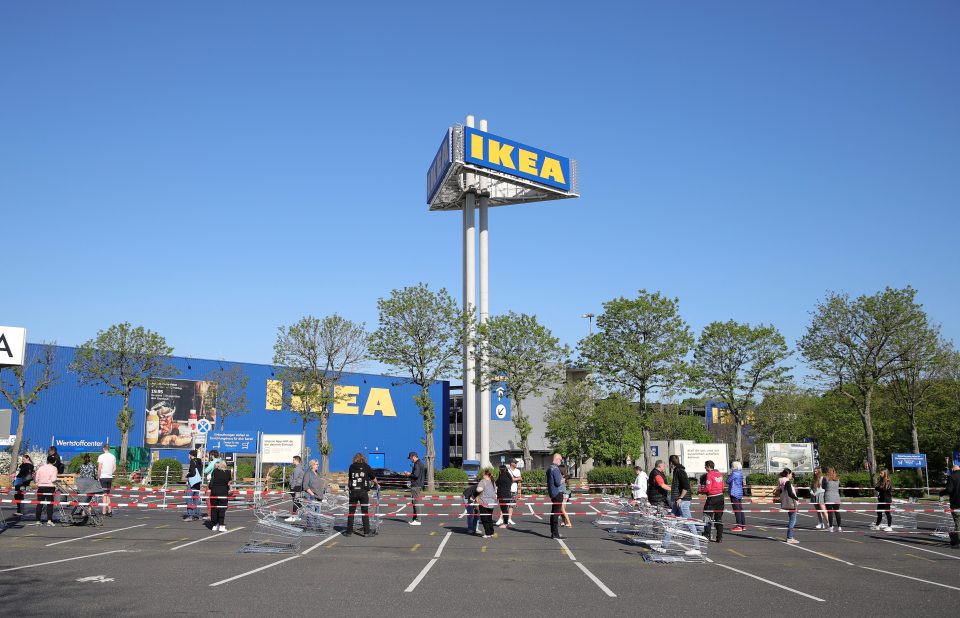 Shoppers queue outside a reopened Ikea store in Cologne, Germany