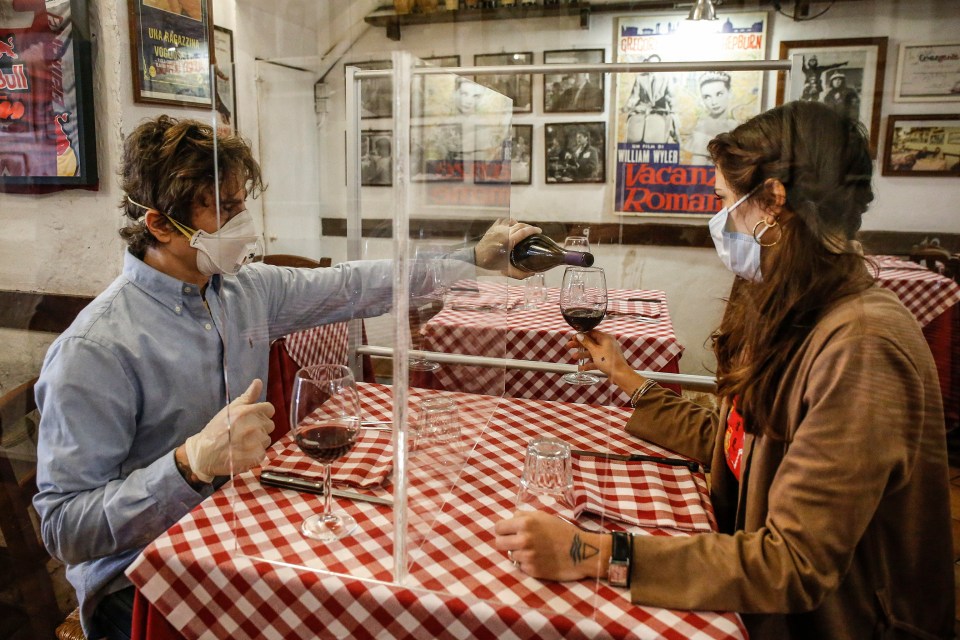 A plexiglass separator between tables could be the new normal as European cities start to lift their lockdown measures