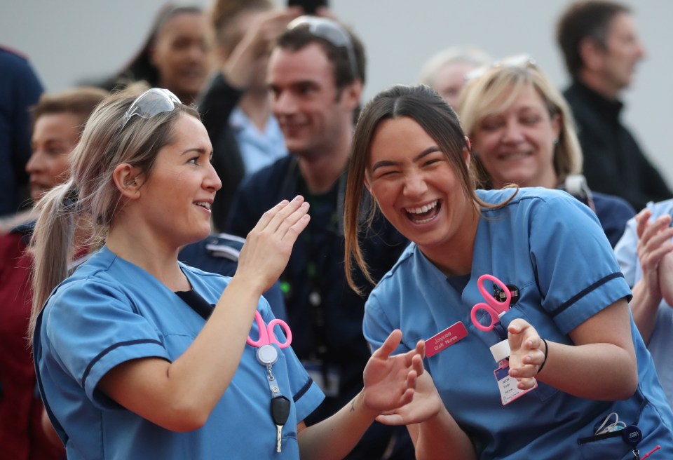 Medical staff react outside Queen Elizabeth Hospital during the fifth Clap For Carers campaign