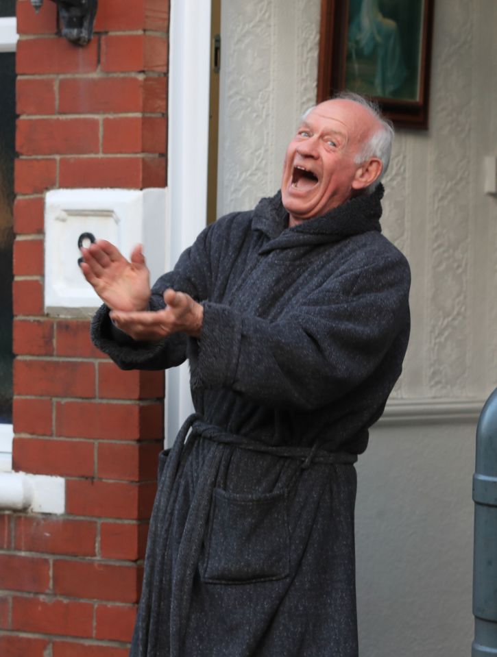  A resident in Marine Gardens, Whitley Bay, Tyne and Wear, applauds to salute local heroes