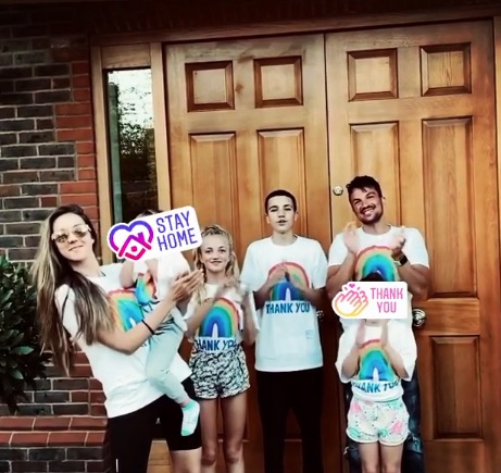  Peter and Emily and their children clapping for the NHS on Thursday outside their home