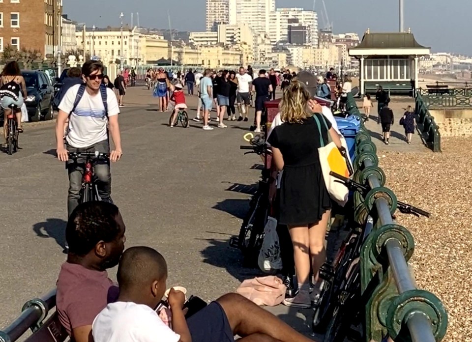  Hundreds of locals were seen strolling along the Hove seafront in East Sussex to enjoy the sunshine today