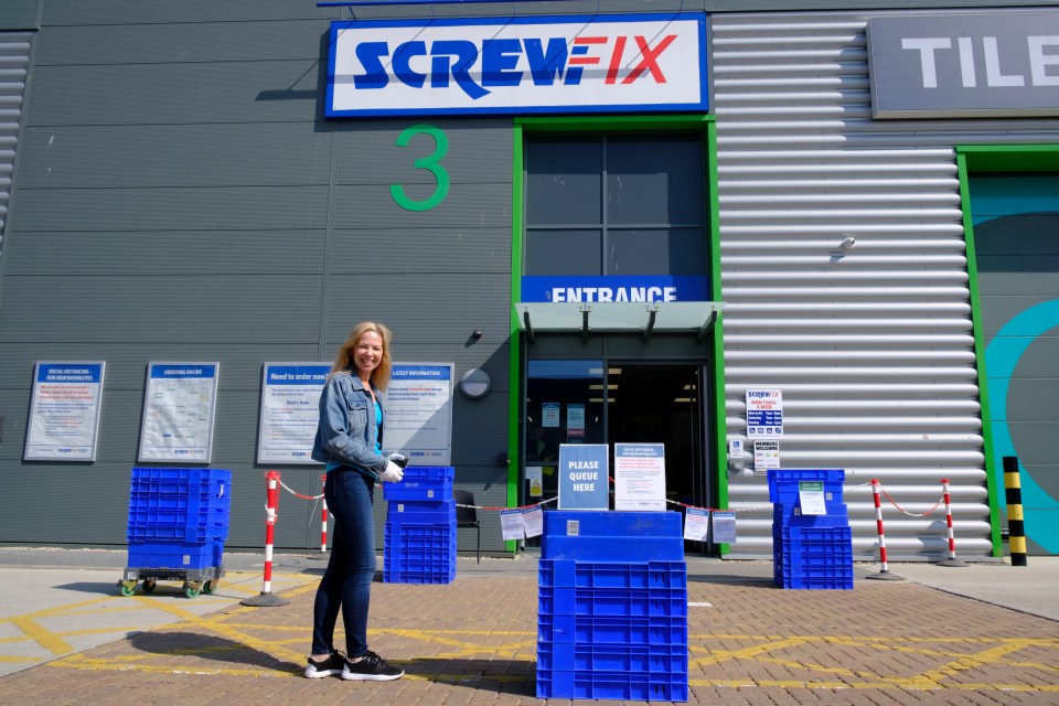  A woman waits for the items she has purchased at the Screwfix store in Chelmsford as stores across the country start to open