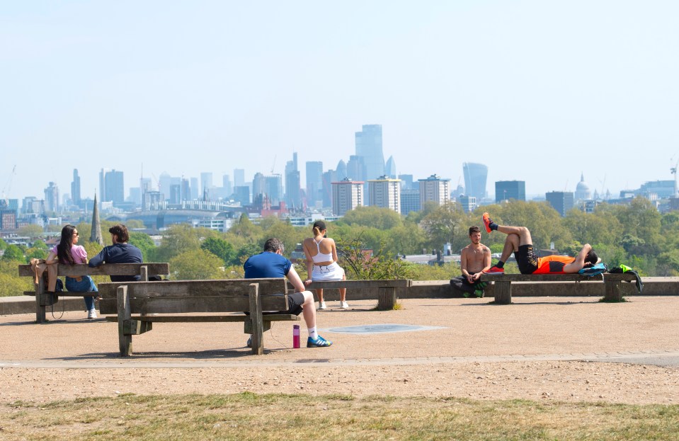  Members of the public ignore the coronavirus lockdown by sunbathing and enjoying the sunny weather on Primrose Hill in London