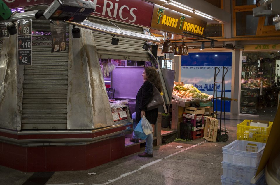  A single customer at the deserted Santa Caterina market in Barcelona, Spain