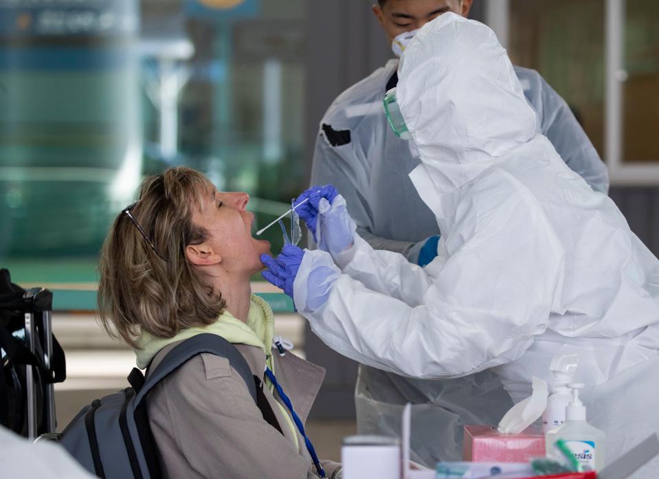 A passenger from Europe is tested at Incheon international airport, South Korea