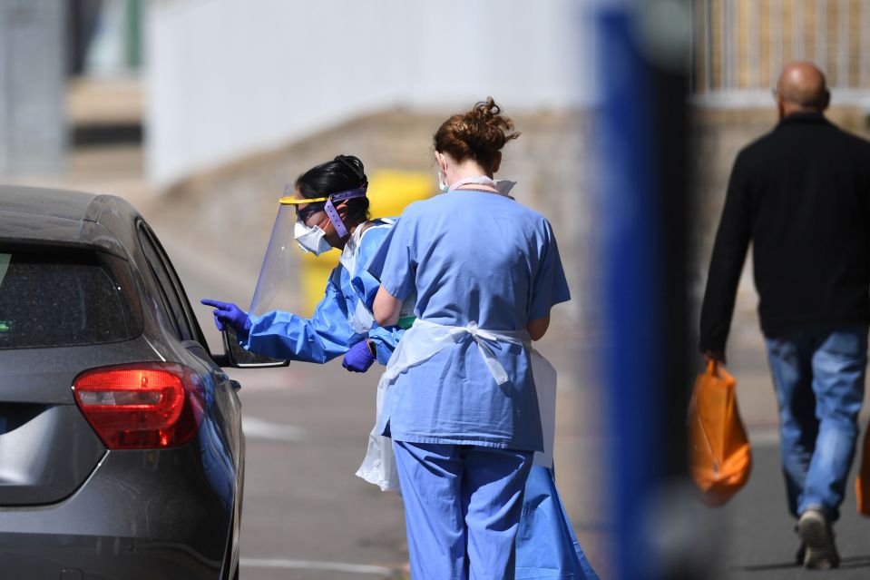 Medical workers at a drive-in testing facility in East London on April 25