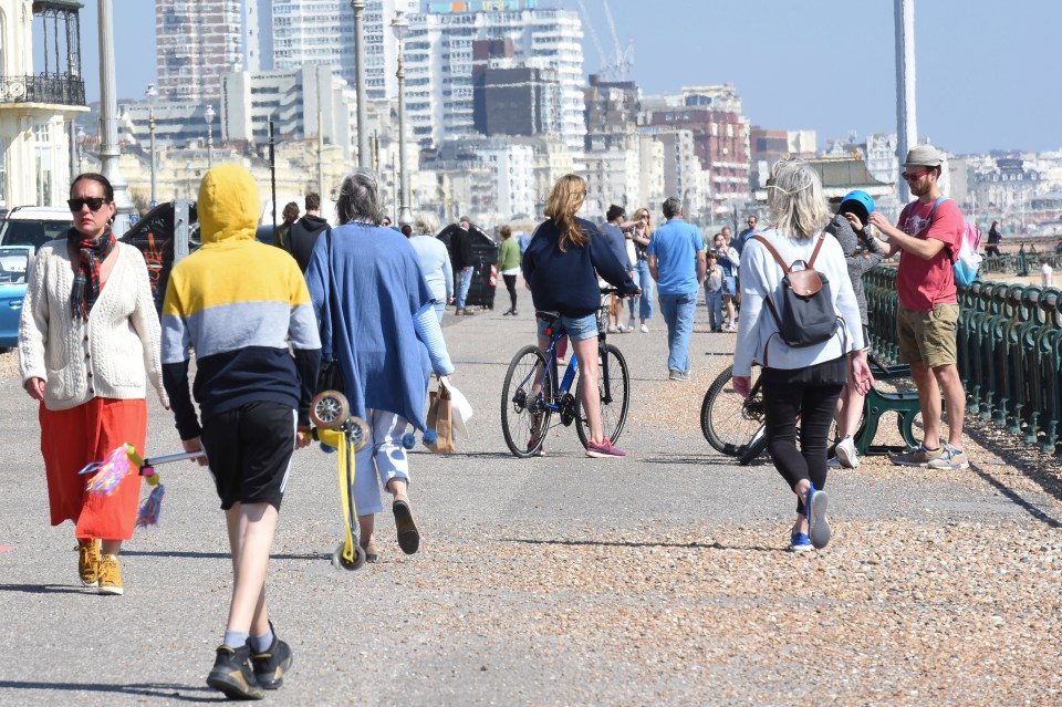  The Brighton seafront is still bustling and full of people - keeping their distance as they walk