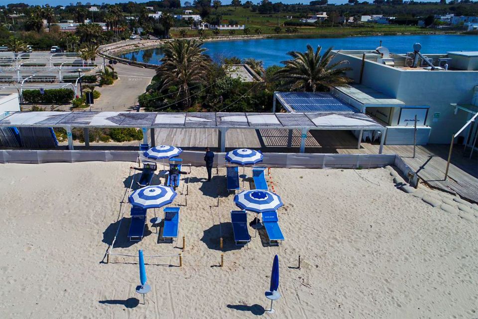  Bacino Grande beach manager Fabrizio Marzano has lined up sunshades and delimits spaces with thin cords