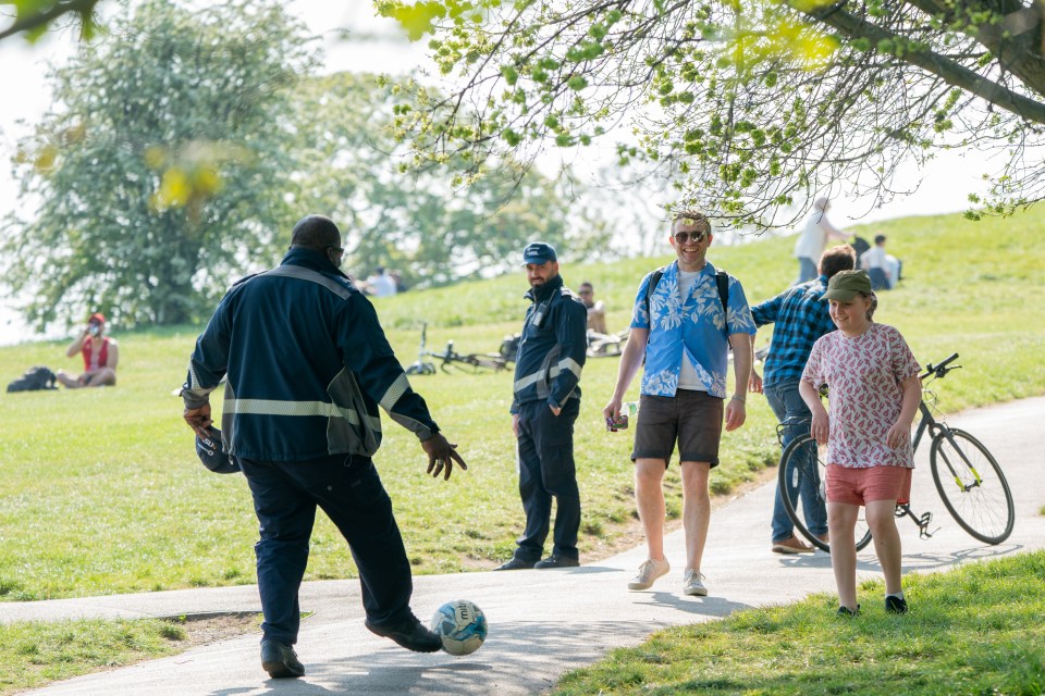  A traffic warden takes part in a kickabout in Primrose Hill today