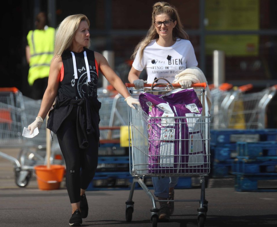  Two women leave B&Q in York with a full trolley