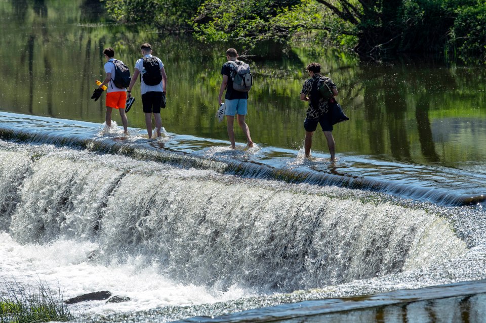  People enjoy the weather at Warleigh Weir on the River Avon in Somerset