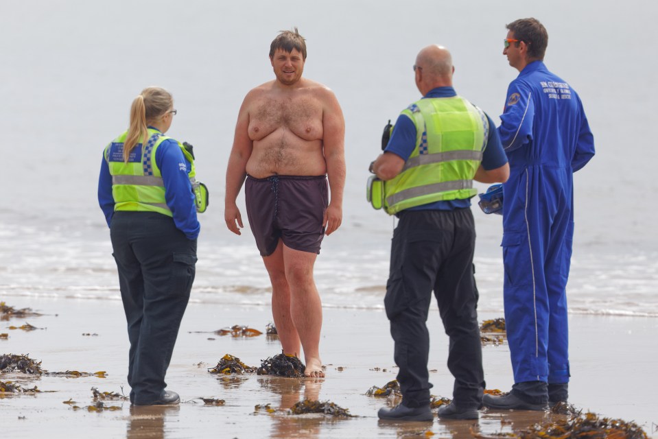  Cops chat to a man in the sea in Swansea