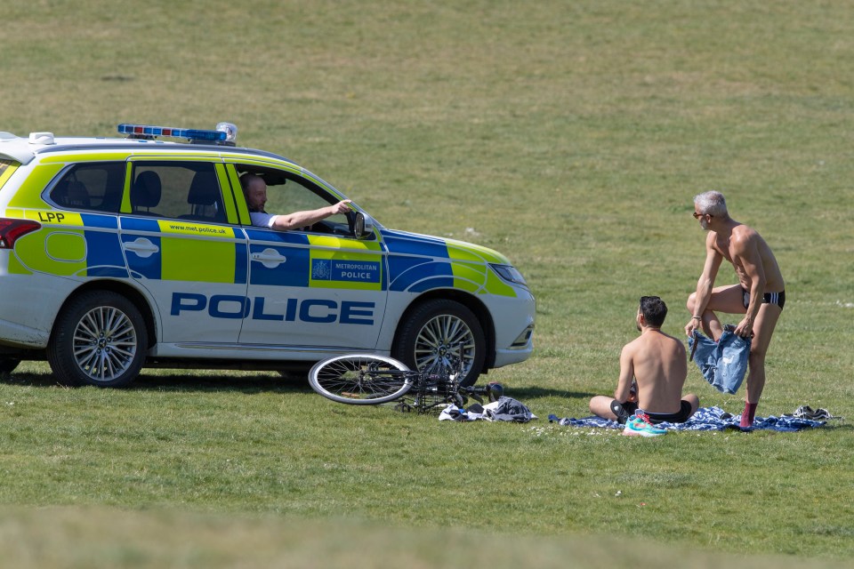  Cops speak to sunbathers as they patrol Greenwich Park, London