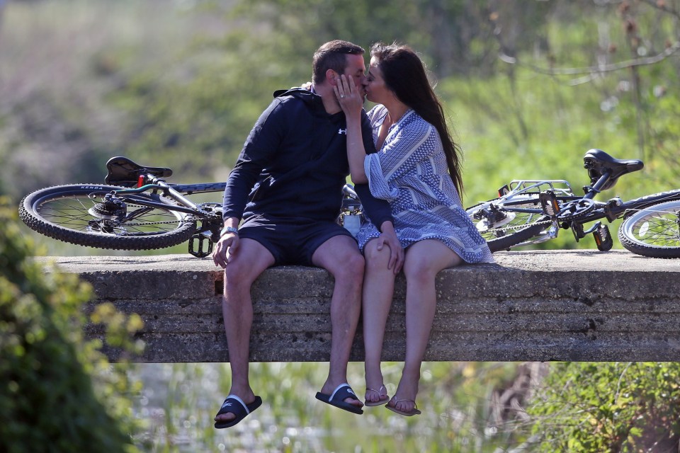  The couple shared a kiss on the bridge as they took a break on a bike ride