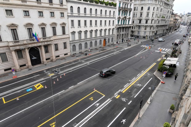 A usually gridlocked road in Milan is now deserted with bikes taking priority