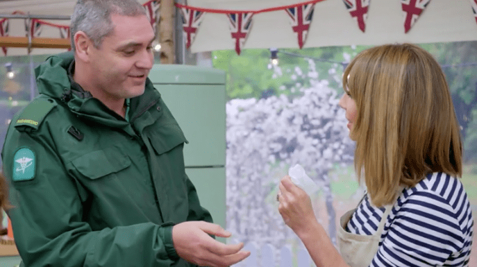 Alex gets treatment from a paramedic after slicing her finger