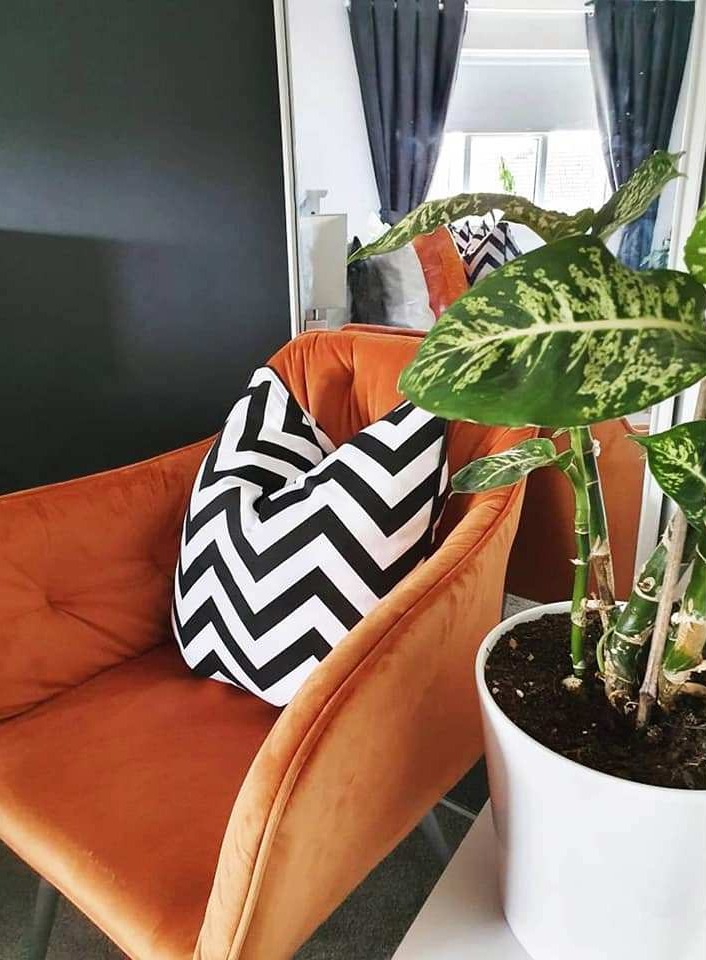 He went for pops of bright orange with matching black-and-white cushion covers