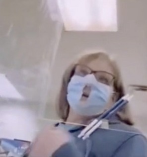 A bizarre video has captured a woman who cut a hole in her medical mask