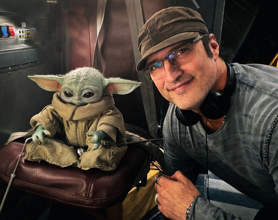  Director Robert Rodriguez poses with Baby Yoda