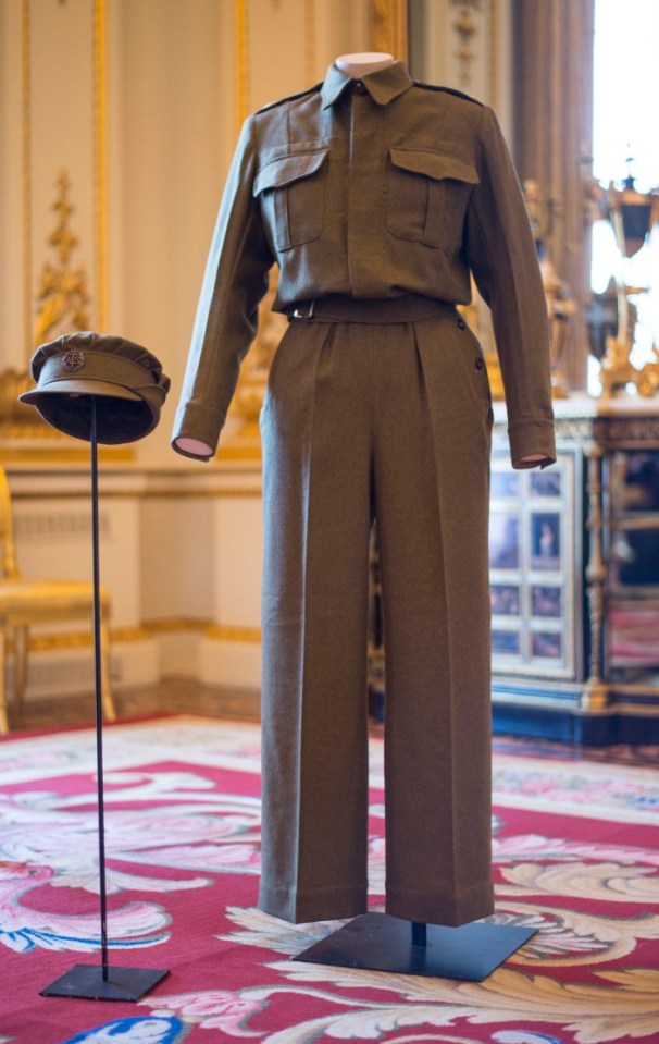  A pair of Auxiliary Territorial Service overalls and a cap, worn by Queen Elizabeth II, then Princess Elizabeth, whilst serving in the wartime ATS, on display at Buckingham Palace in London