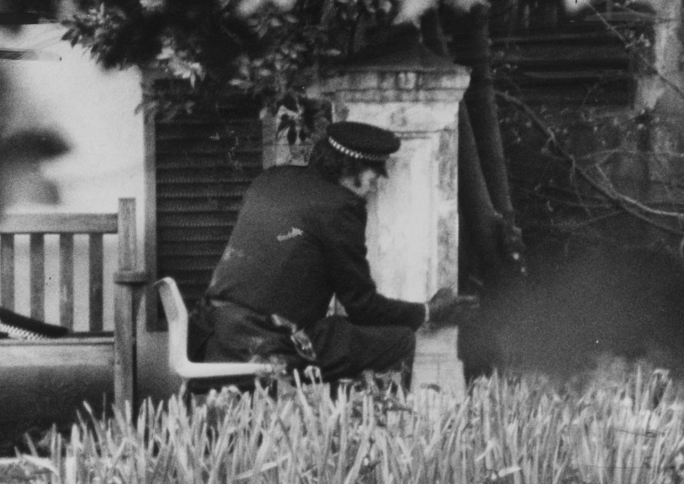  An armed policeman at the rear of the embassy during the siege