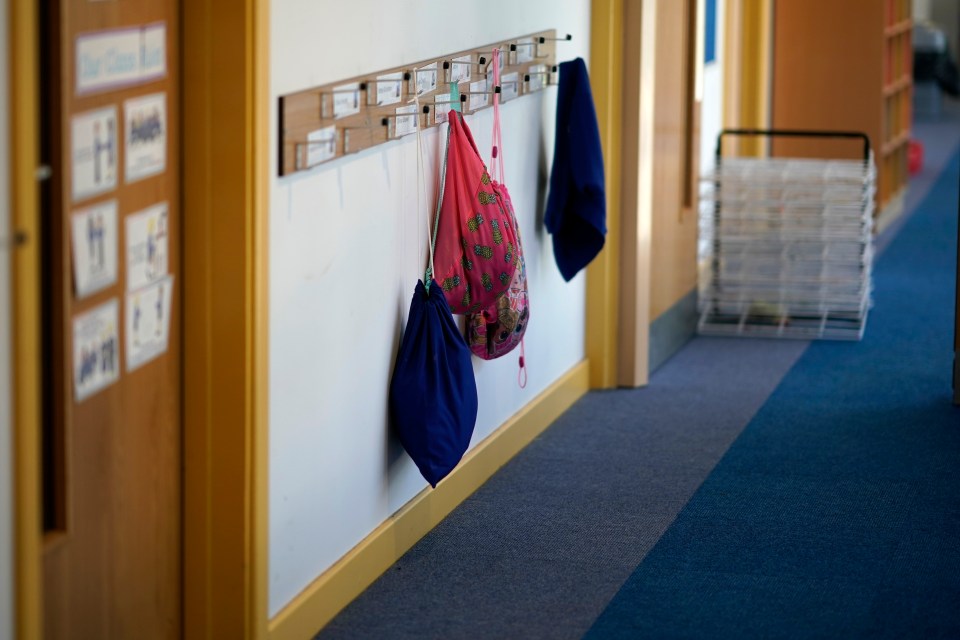  Children's PE bags hang on coat hooks at Oldfield Brow Primary School during the coronavirus lockdown