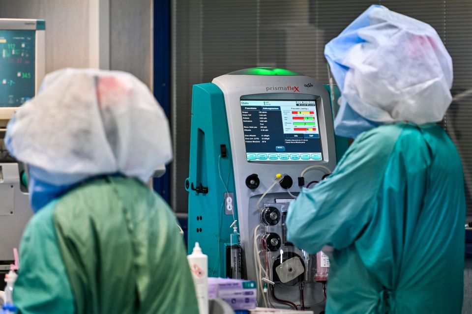  A medical worker wearing protective gear and mask checks a machine at a hospital in Rome on April 21