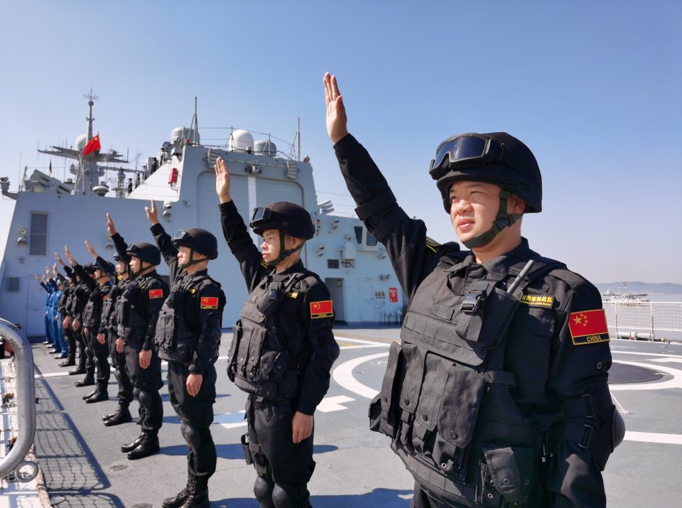  Special forces soldiers wave farewell on the deck in Zhoushan as it deploys for exercises