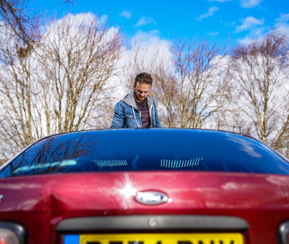  He stands on the bonnet of one of the gang’s cars